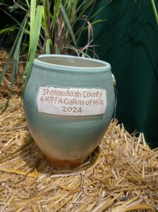 Handmade clay crock with "Shenandaoh County 4H/FFA Gallon of Milk 2024 written on side.